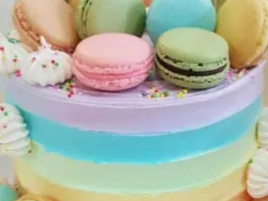 Macaroon Delight cake, pastel buttercream layers finished with macarons
